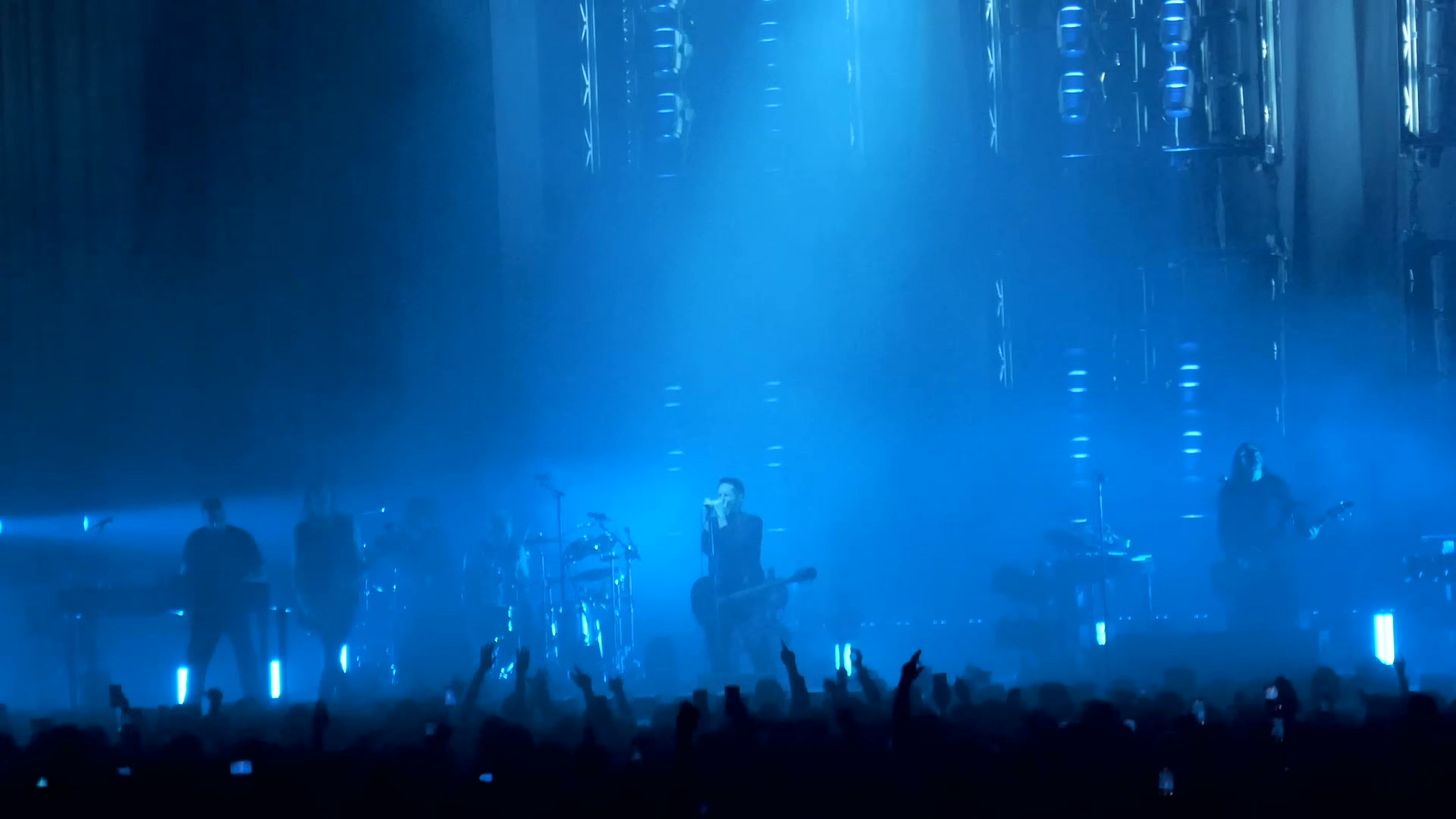 Nine Inch Nails inside a blue-lit stage environment